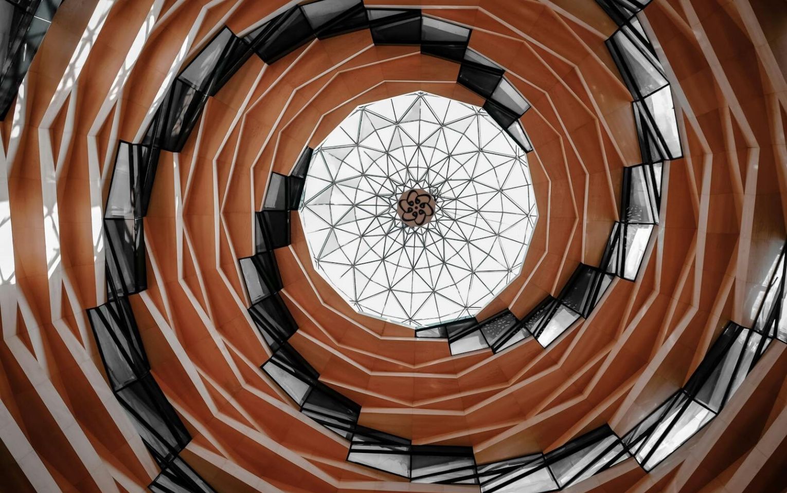 Intricate spiral glass ceiling design in Istanbul, showcasing modern architectural elegance.